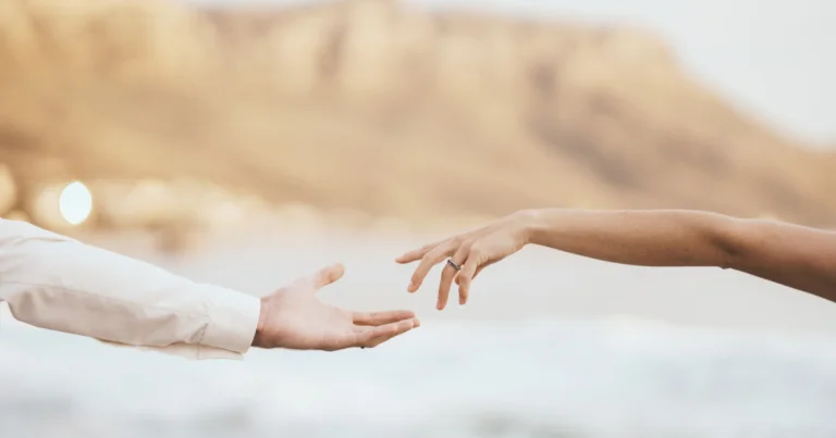 Supportive hands reaching out, representing care through counselling and therapy