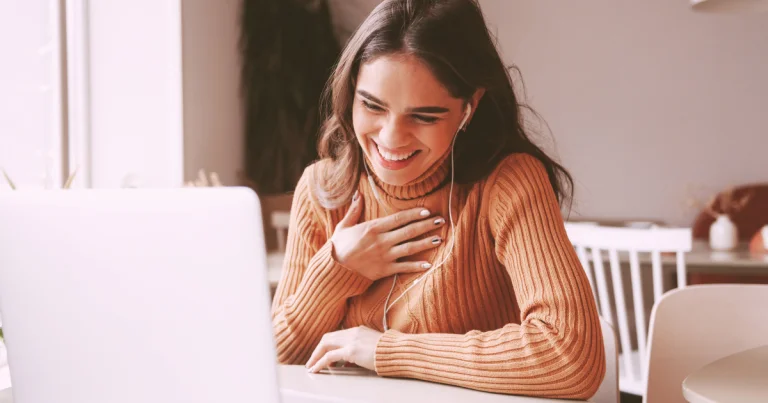 Client smiling during an online therapy session from home